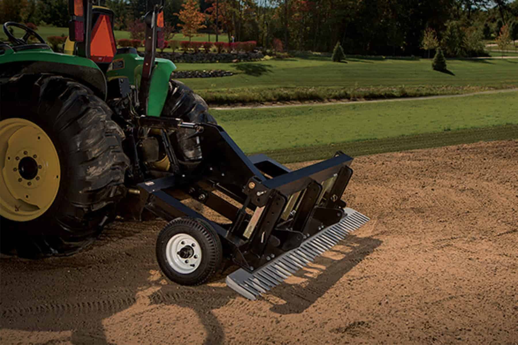 Tractor attachment for leveling soil