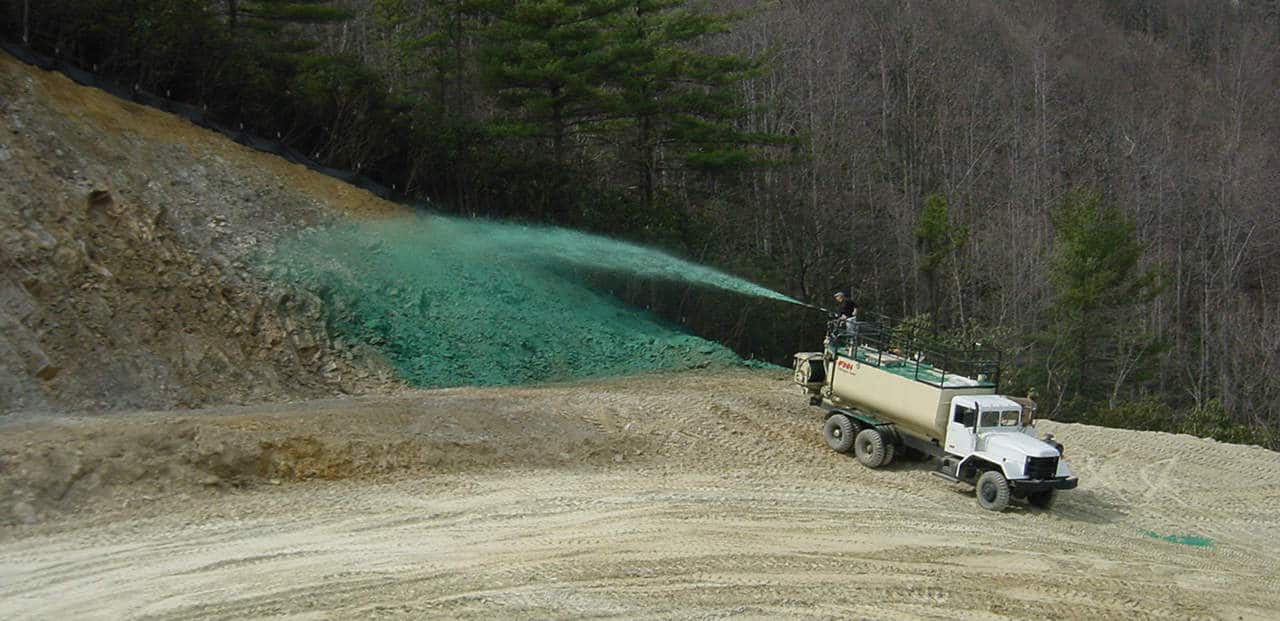 Prevent water erosion with hydroseeding a hydroseeder spraying to prevent water erosion